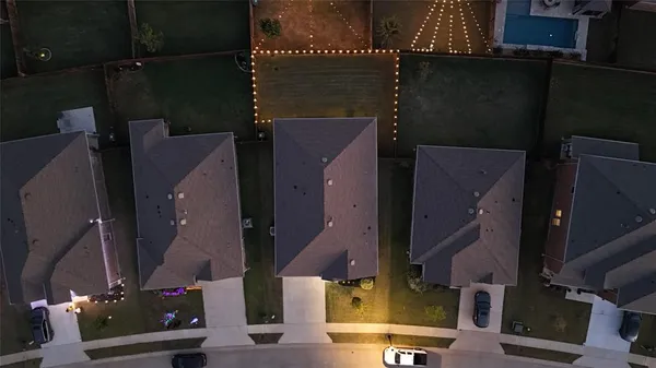 an aerial view of residential houses with outdoor space