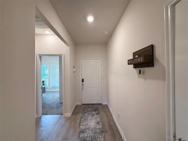 a view of hallway with wooden floor