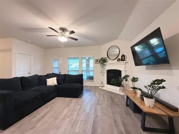 a living room with furniture a fireplace and a flat screen tv