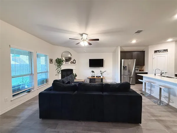 a living room with furniture a fireplace and a flat screen tv