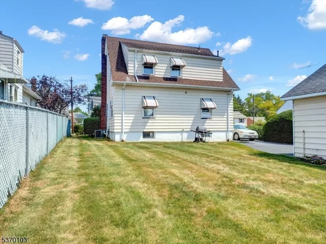 a view of a house with a yard and garage