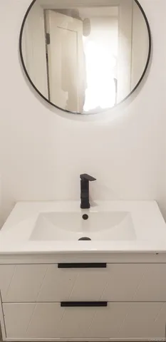 a bathroom with a sink a toilet and a window