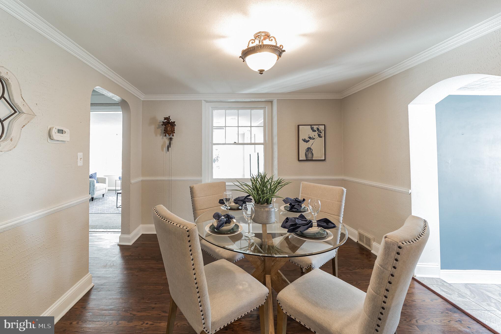 1217 Providence Road Springfield, PA 19064 - Photo 11 of 41 a dining room with furniture a potted plant and wooden floor