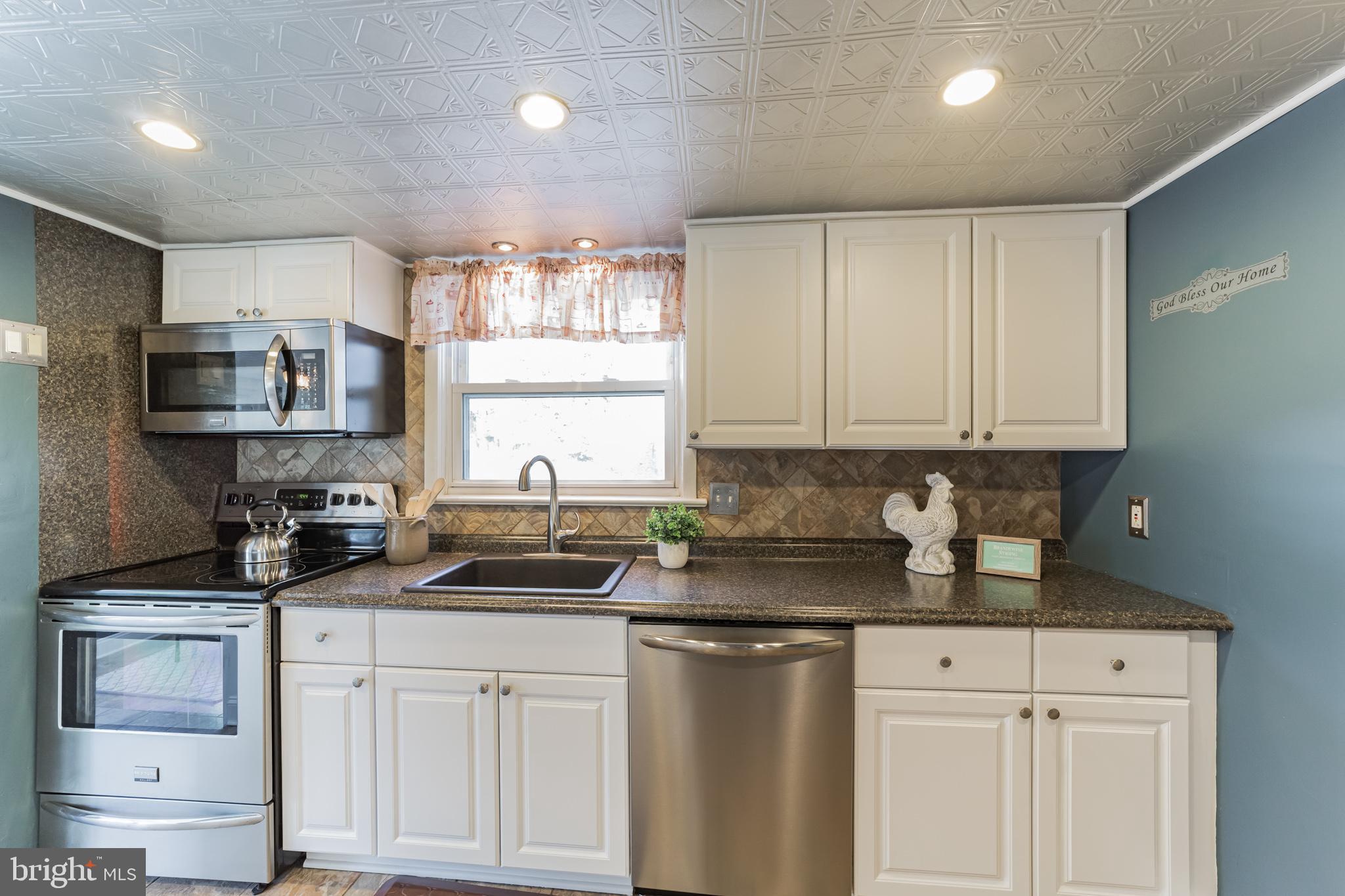 1217 Providence Road Springfield, PA 19064 - Photo 15 of 41 a kitchen with granite countertop white cabinets and white appliances