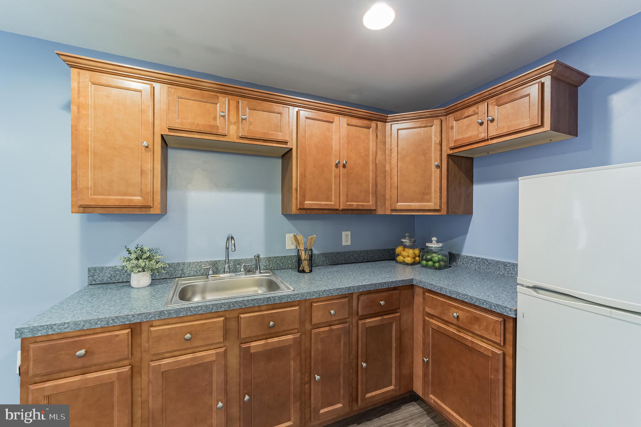 1217 Providence Road Springfield, PA 19064 - Photo 27 of 41 a kitchen with stainless steel appliances granite countertop a refrigerator sink and cabinets