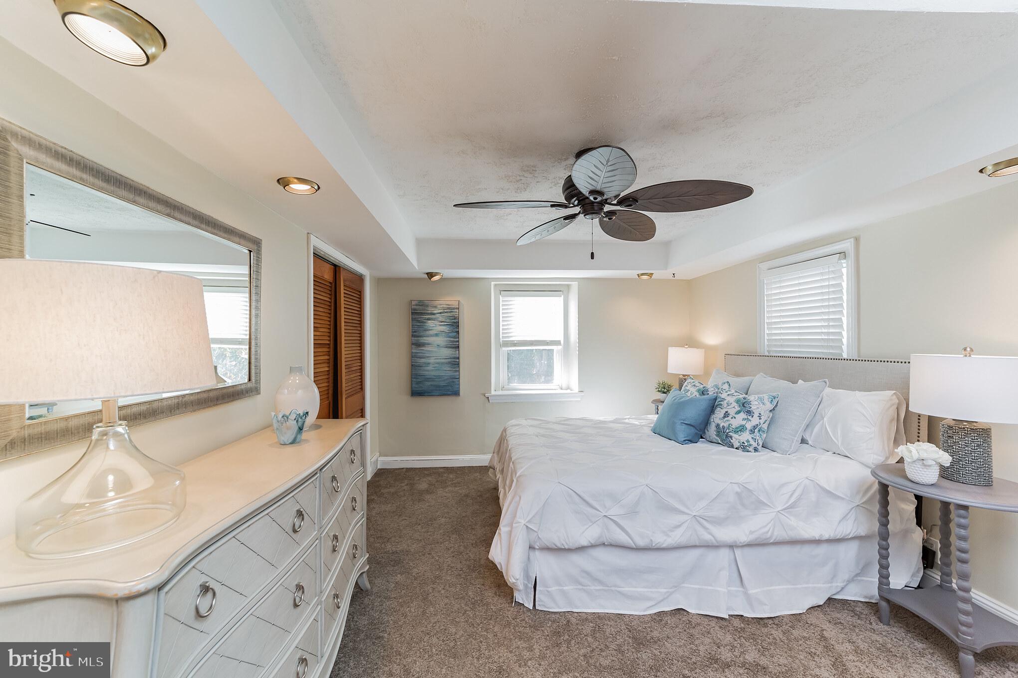 1217 Providence Road Springfield, PA 19064 - Photo 31 of 41 a spacious bedroom with a large bed and a chandelier
