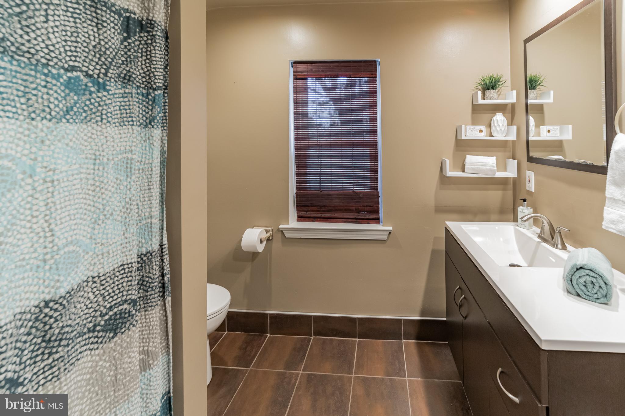 1217 Providence Road Springfield, PA 19064 - Photo 35 of 41 a bathroom with a sink a toilet and shower