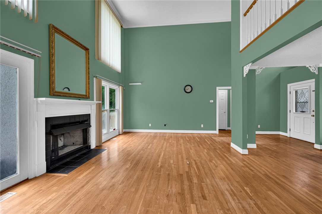 1016 Campbell Road Belton, SC 29627 - Photo 7 of 50 Grand living room features soaring ceilings, a stately fireplace, and rich hardwood flooring.