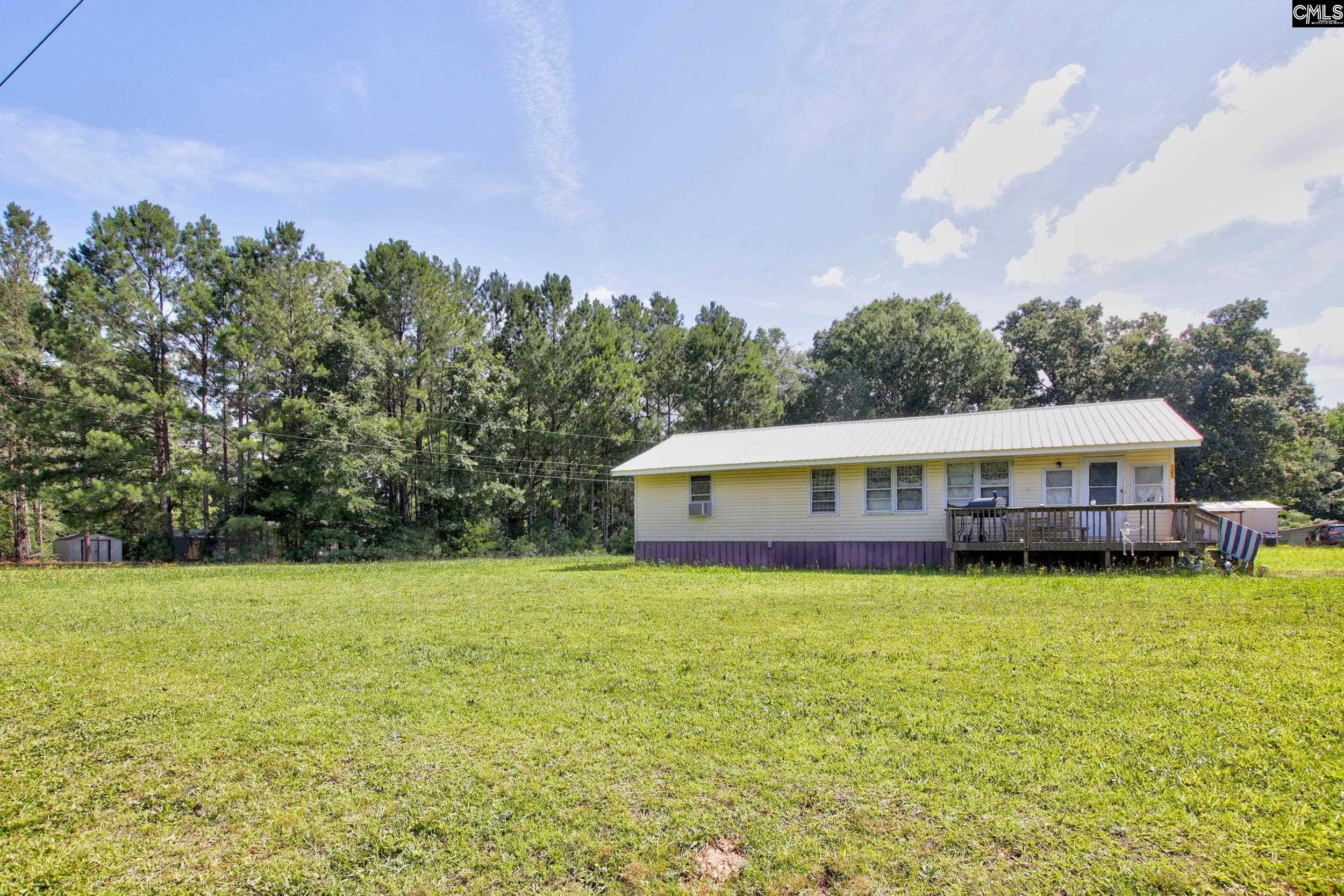 3140 Highway 702 Chappells, SC 29037 - Photo 32 of 39 a house with a garden in front of it