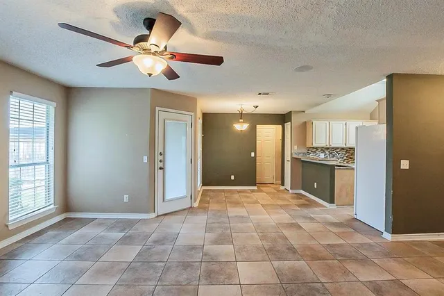 a view of an empty room with a kitchen