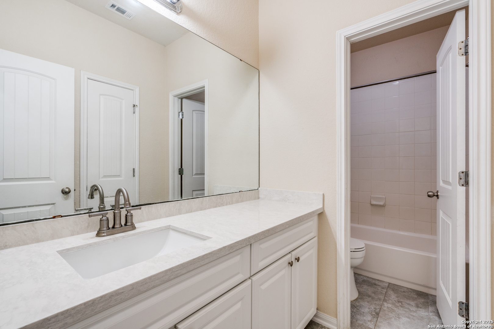 313 South 6th Street Kenedy, TX 78119 - Photo 31 of 37 a bathroom with a tub sink and mirror