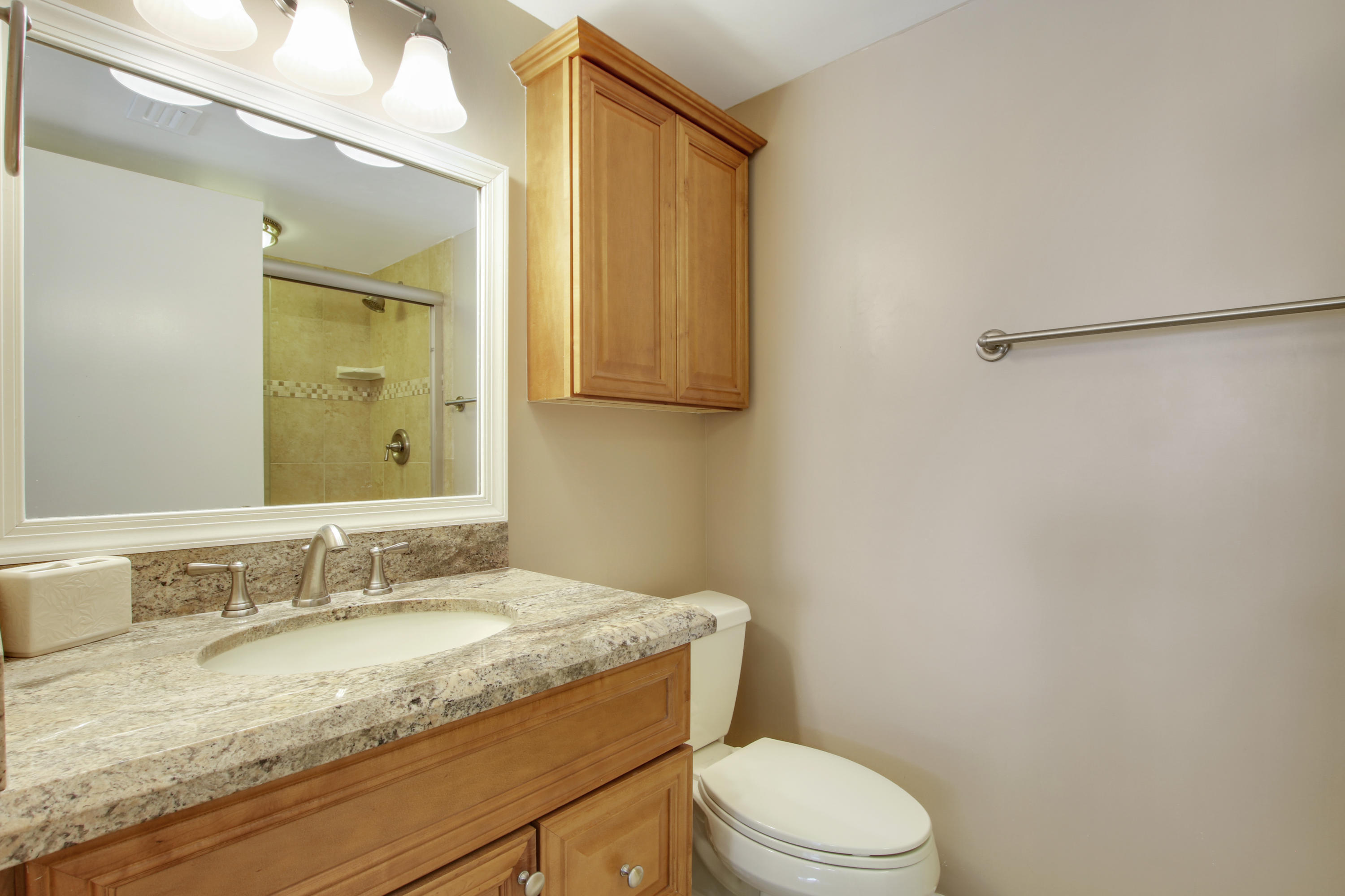 353 Highway 1, Unit C105 Jupiter, FL 33477 - Photo 18 of 33 a bathroom with a granite countertop sink toilet and mirror