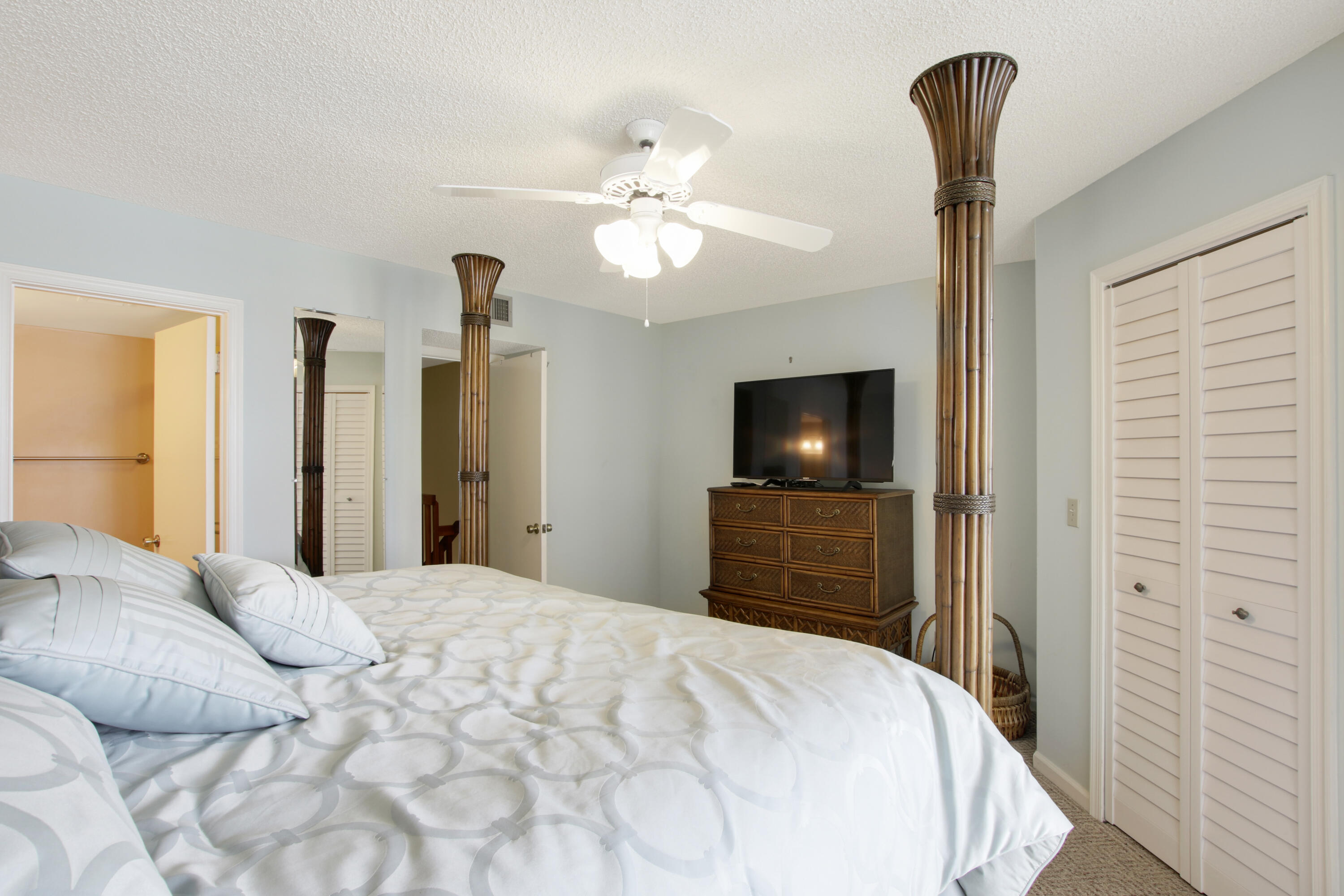 353 Highway 1, Unit C105 Jupiter, FL 33477 - Photo 19 of 33 a bedroom with a bed and a flat screen tv