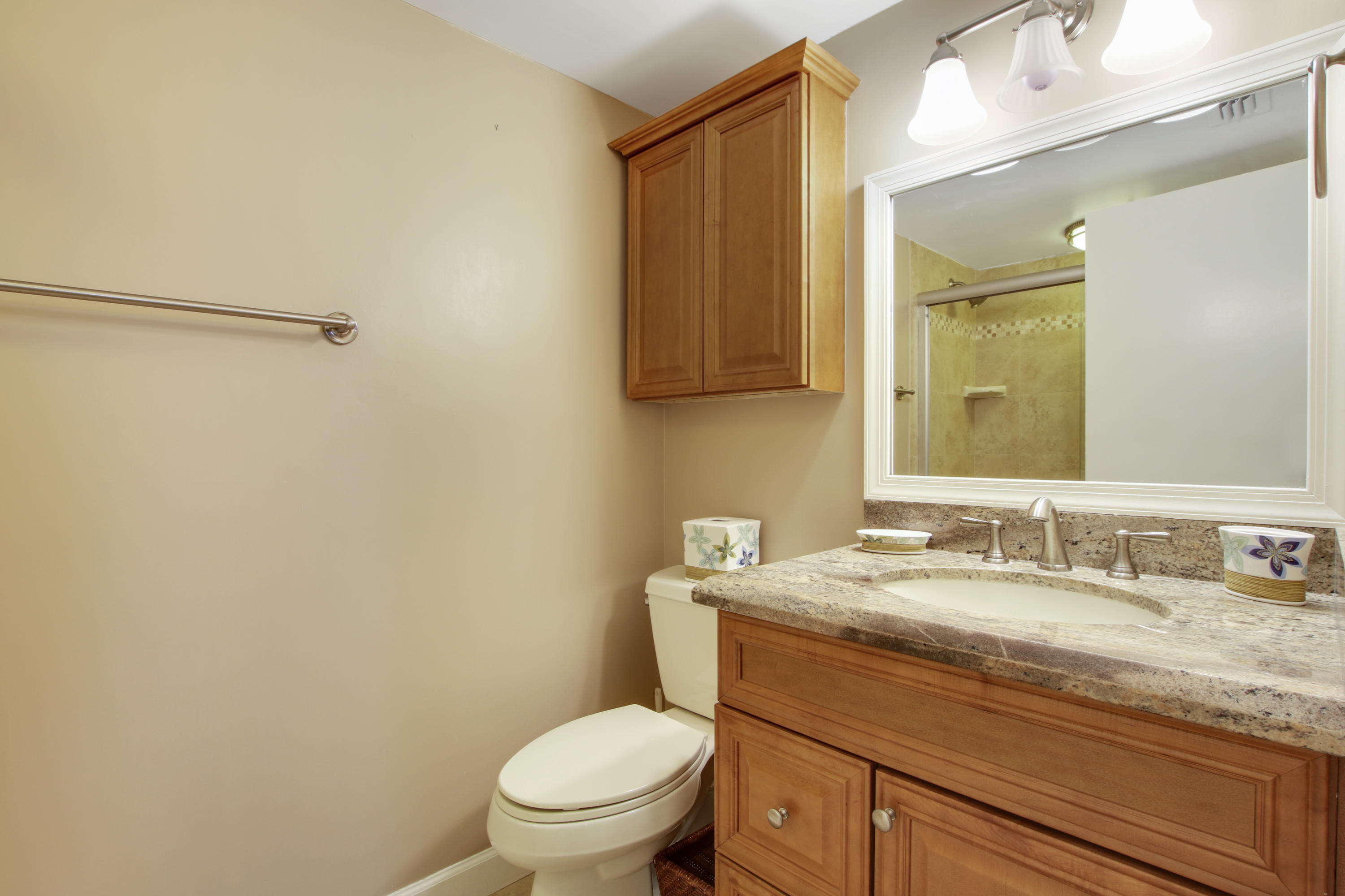 353 Highway 1, Unit C105 Jupiter, FL 33477 - Photo 21 of 33 a bathroom with a granite countertop sink mirror vanity and toilet