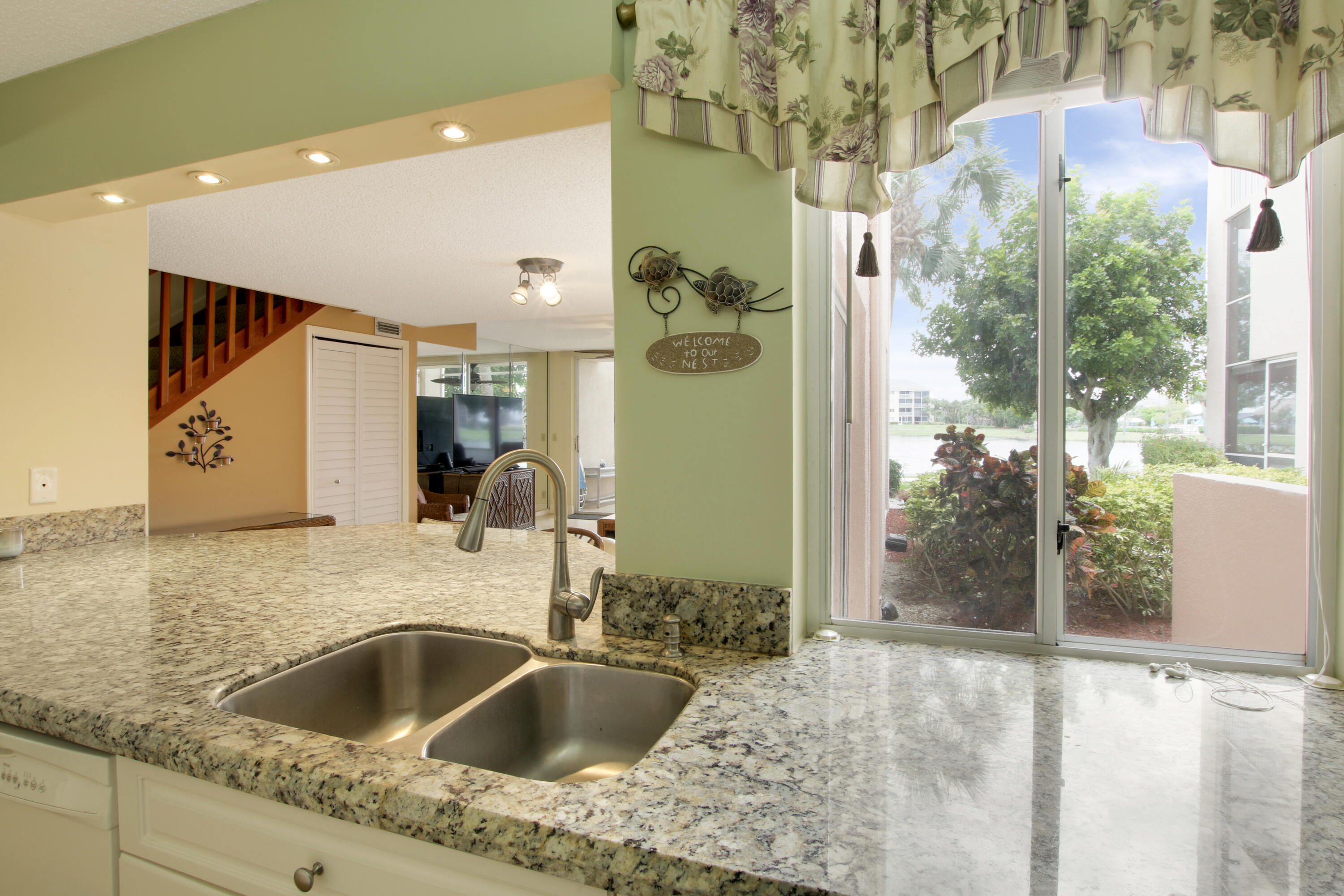 353 Highway 1, Unit C105 Jupiter, FL 33477 - Photo 3 of 33 a kitchen with a granite countertop sink and natural light