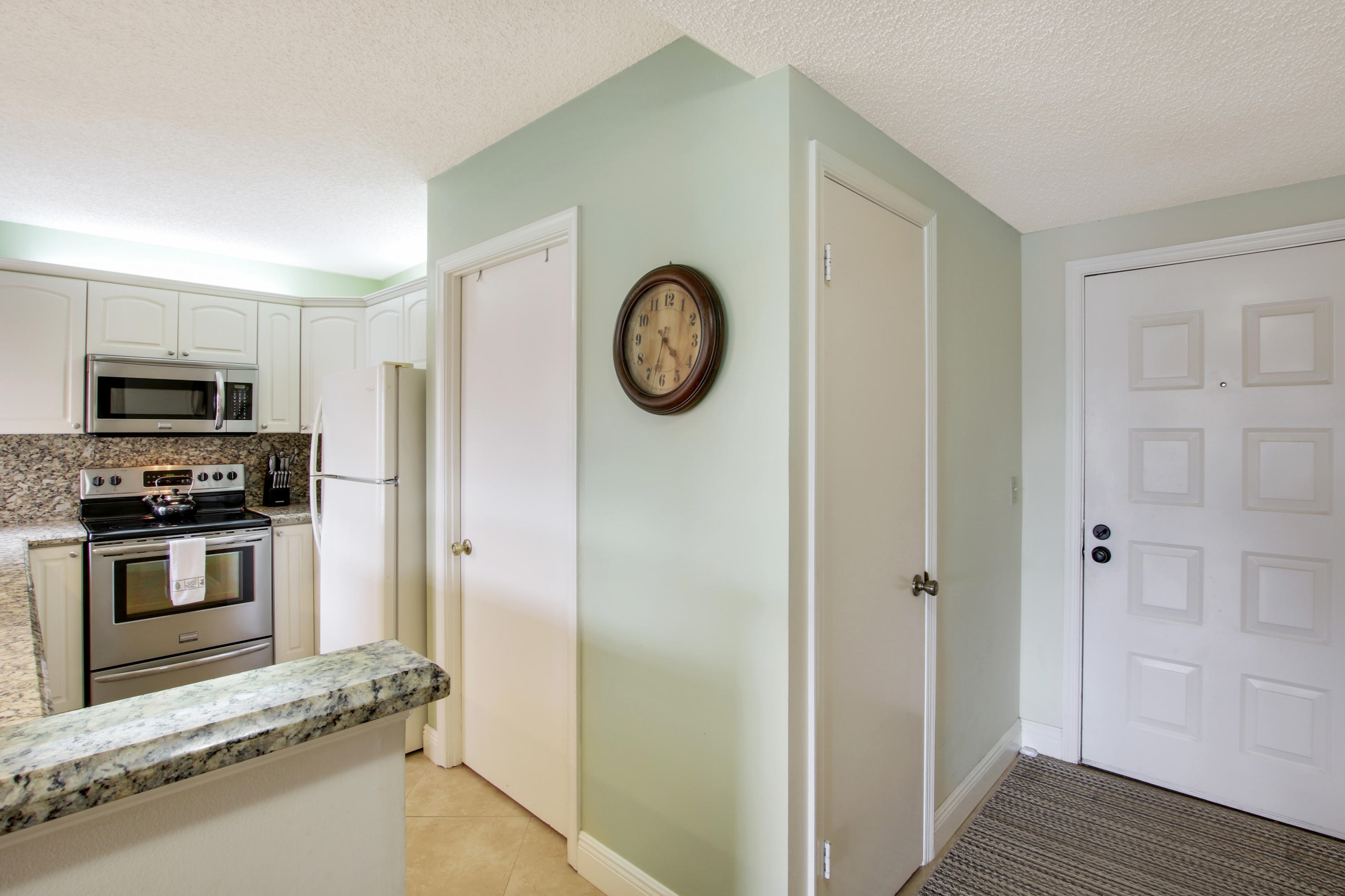353 Highway 1, Unit C105 Jupiter, FL 33477 - Photo 6 of 33 a kitchen with a refrigerator and a stove top oven