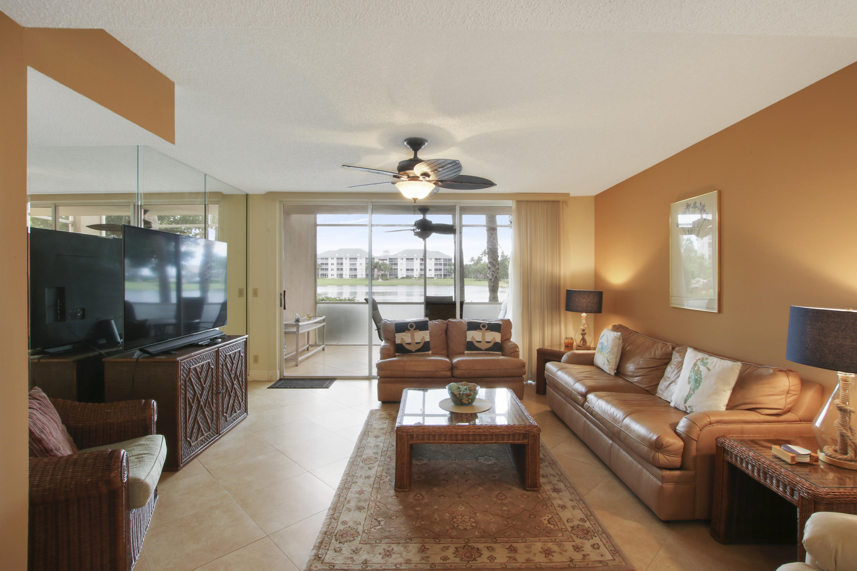 353 Highway 1, Unit C105 Jupiter, FL 33477 - Photo 9 of 33 a living room with furniture and a flat screen tv