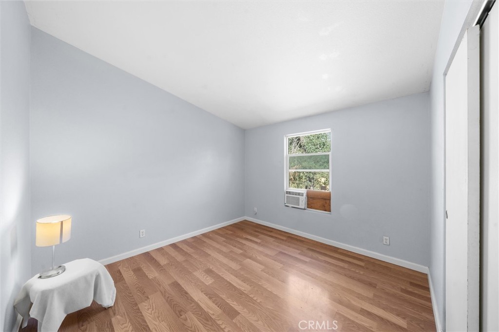 16080 Oakridge Road Corning, CA 96021 - Photo 17 of 39 a view of a bedroom with wooden floor and window