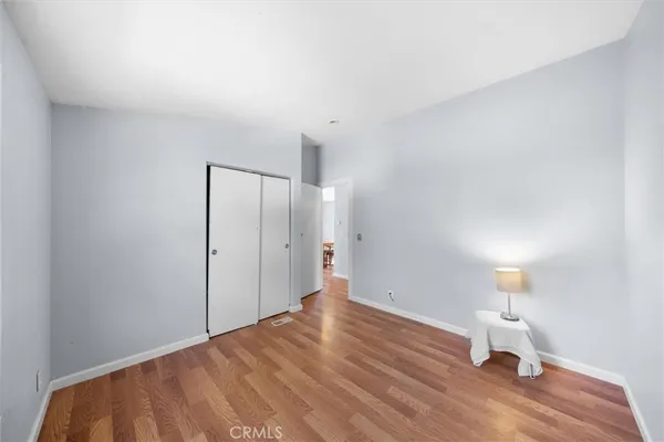 a view of a room with wooden floor