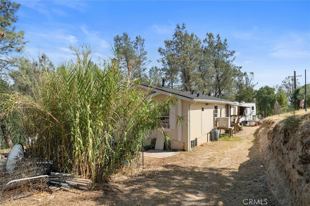 16080 Oakridge Road Corning, CA 96021 - Photo 29 of 39 a view of a grey house with a large tree