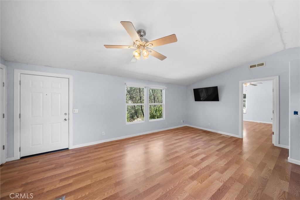 16080 Oakridge Road Corning, CA 96021 - Photo 7 of 39 a view of an empty room with wooden floor and a window
