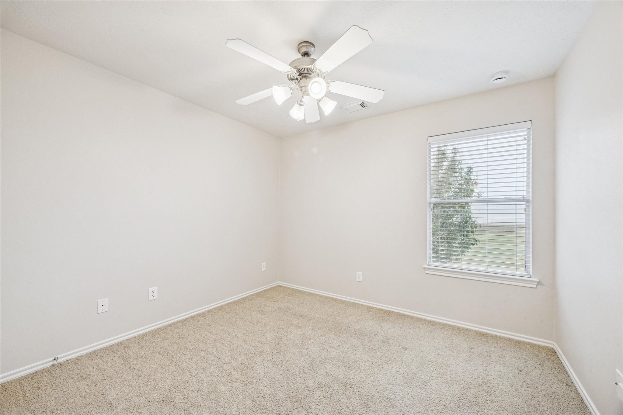 3206 Pearl Bluff Lane Houston, TX 77047 - Photo 15 of 20 an empty room with a window and a fan