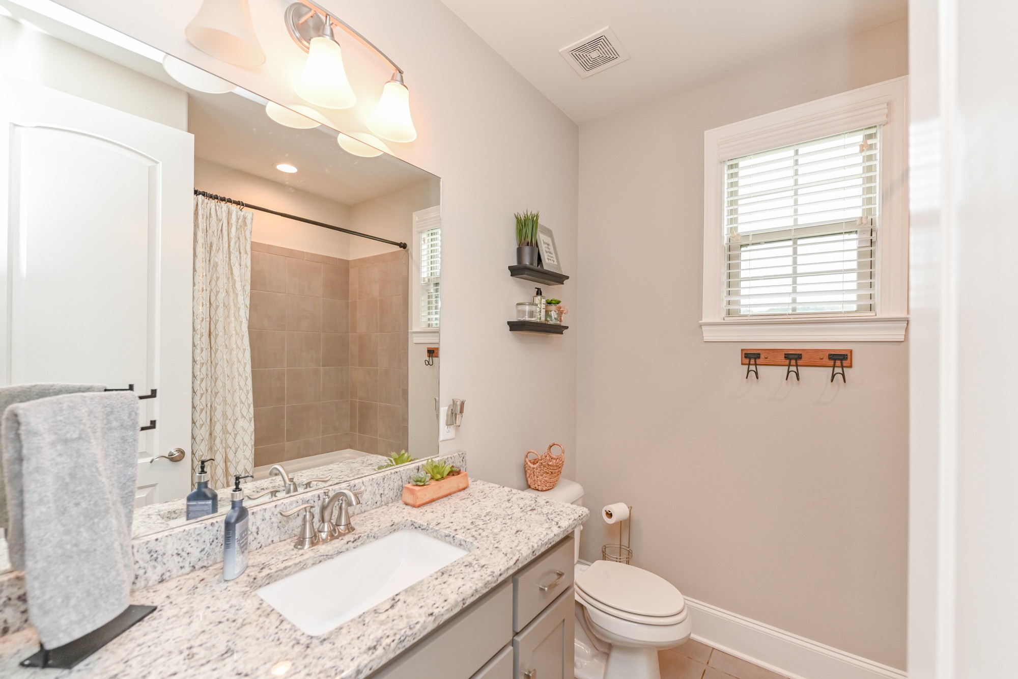 1431 Center Point Road Hendersonville, TN 37075 - Photo 14 of 20 a bathroom with a granite countertop sink toilet a large mirror and shower