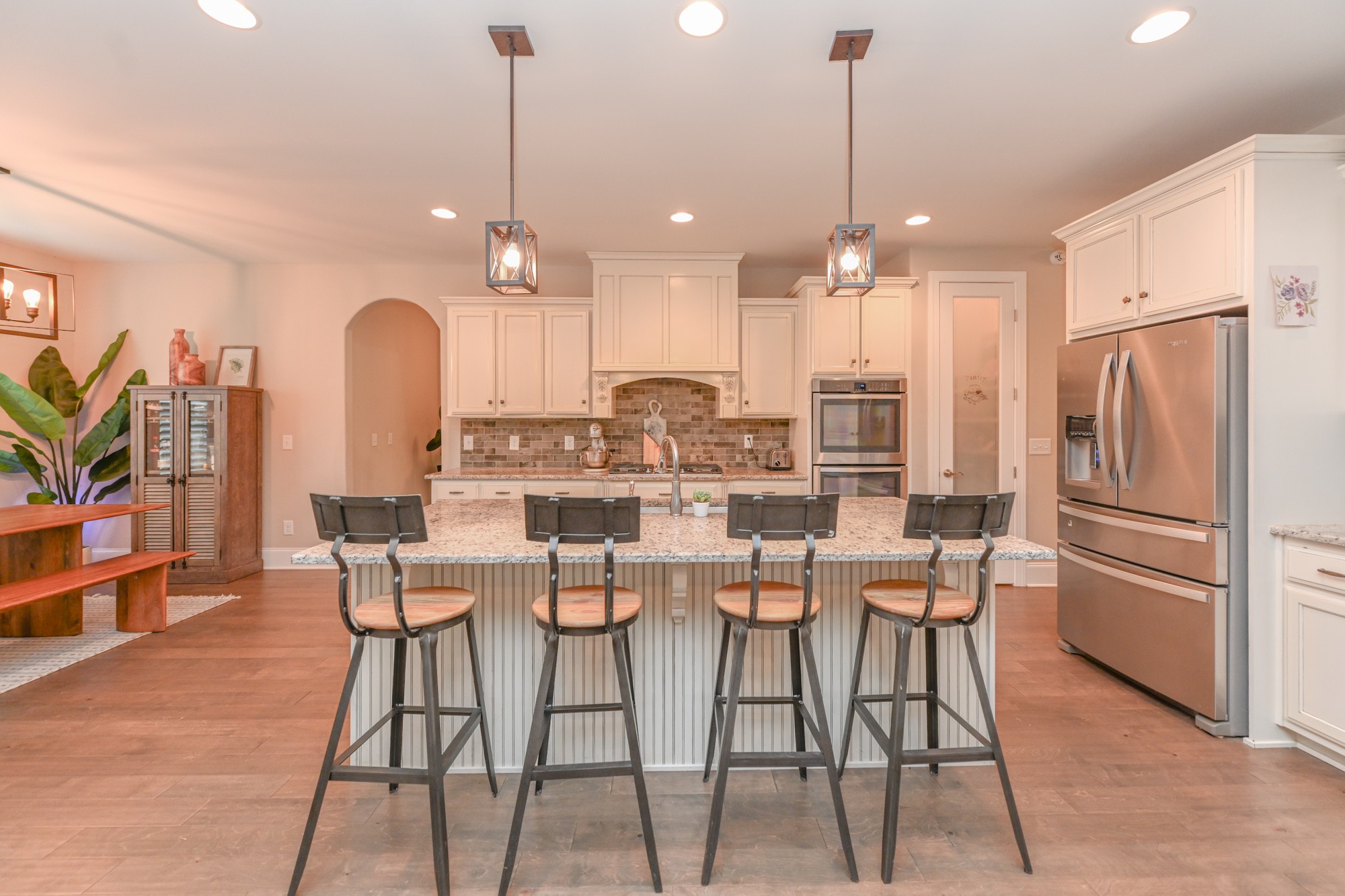 1431 Center Point Road Hendersonville, TN 37075 - Photo 7 of 20 a kitchen with stainless steel appliances kitchen island granite countertop a dining table chairs and white cabinets
