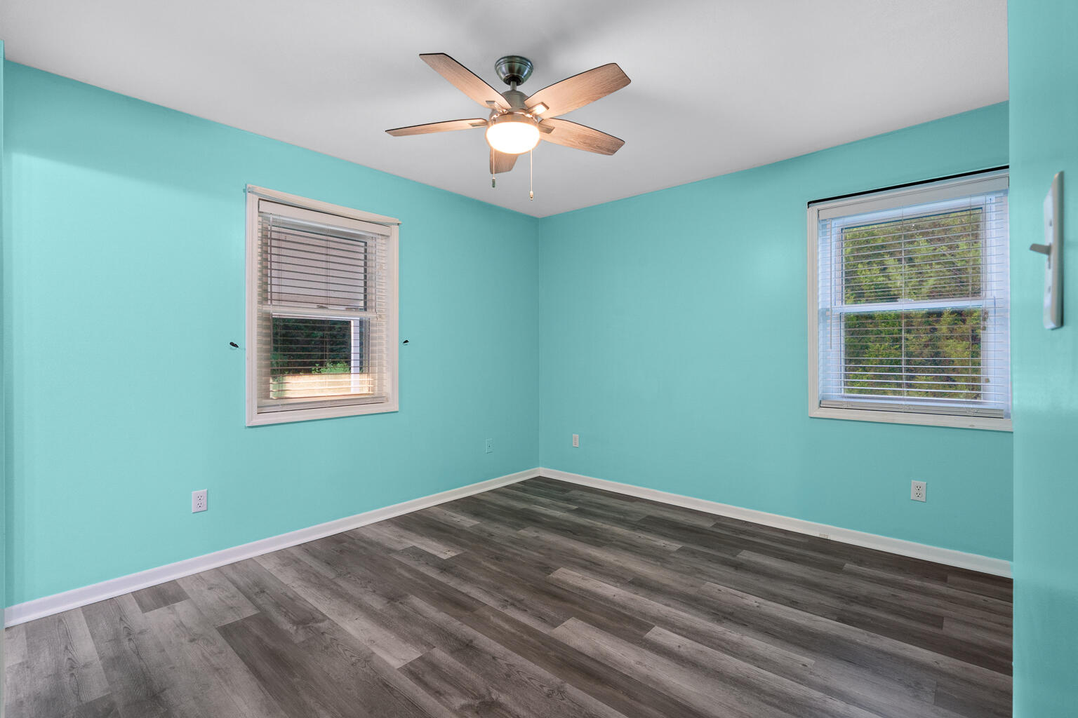 3961 Painter Branch Road Crestview, FL 32539 - Photo 13 of 49 a view of a room with window ceiling fan and hardwood floor