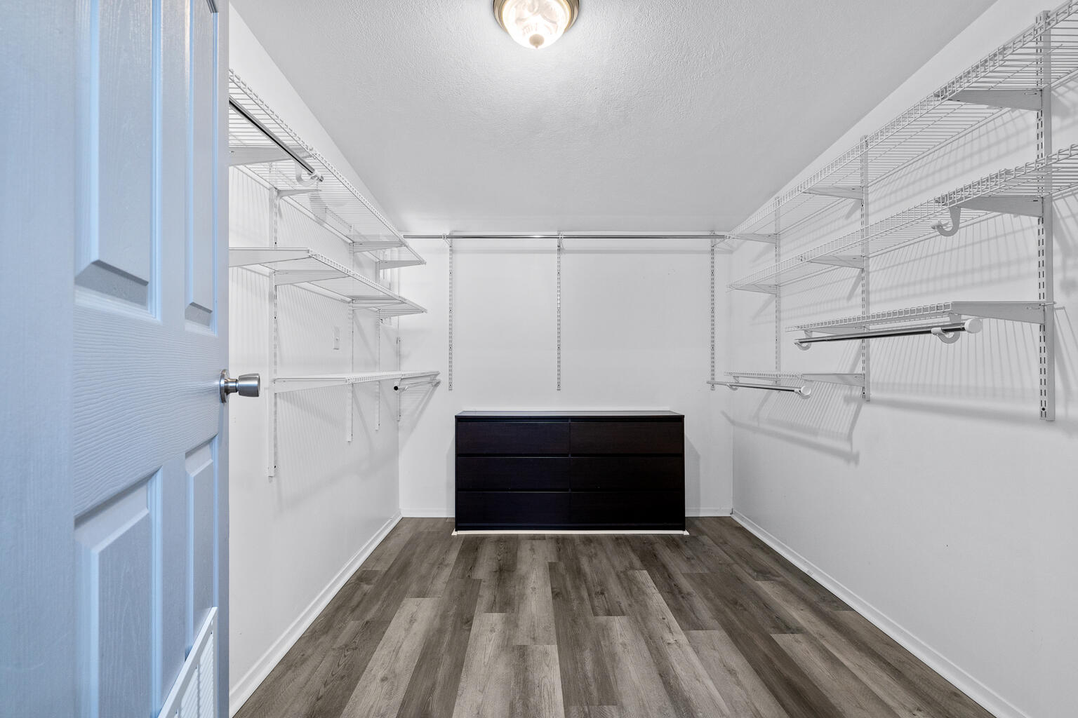 3961 Painter Branch Road Crestview, FL 32539 - Photo 17 of 49 a view of walk in closet with wooden floor