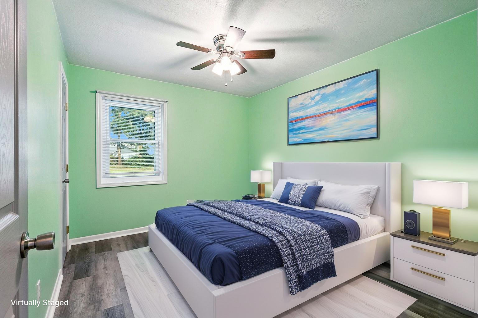 3961 Painter Branch Road Crestview, FL 32539 - Photo 20 of 49 a spacious bedroom with a bed and a painting on the wall