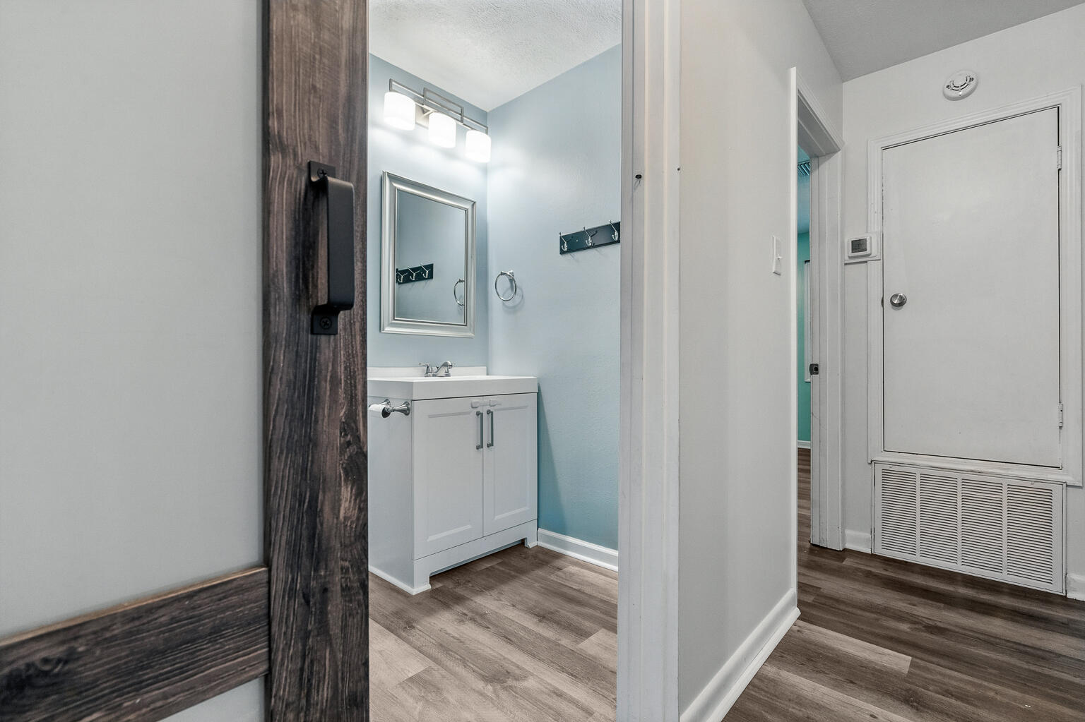 3961 Painter Branch Road Crestview, FL 32539 - Photo 28 of 49 a view of a hallway with a door and wooden floor
