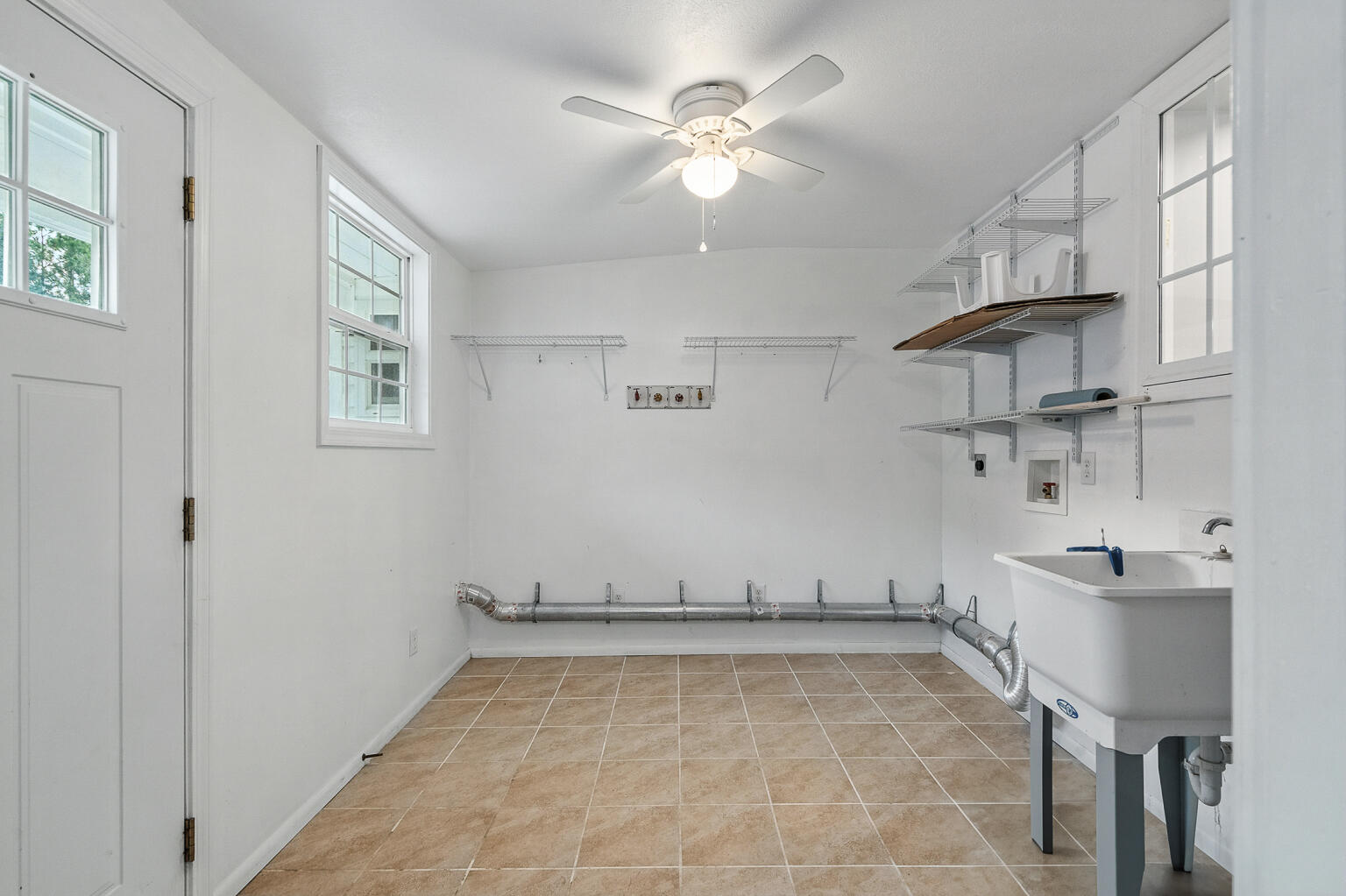 3961 Painter Branch Road Crestview, FL 32539 - Photo 30 of 49 a view of a kitchen with cabinets and wooden floor