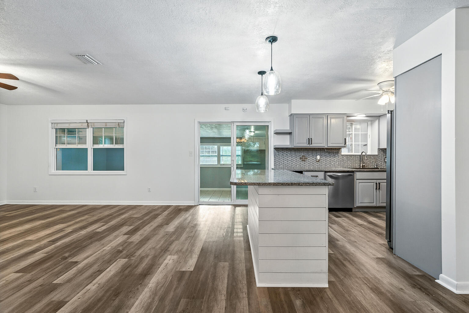 3961 Painter Branch Road Crestview, FL 32539 - Photo 38 of 49 a kitchen with kitchen island a stove a sink and a refrigerator