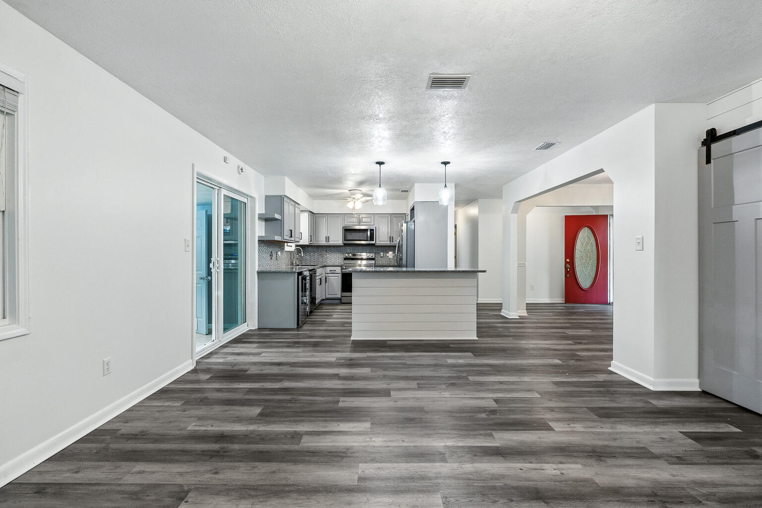 3961 Painter Branch Road Crestview, FL 32539 - Photo 40 of 49 a view of a kitchen with kitchen island wooden floor and stainless steel appliances