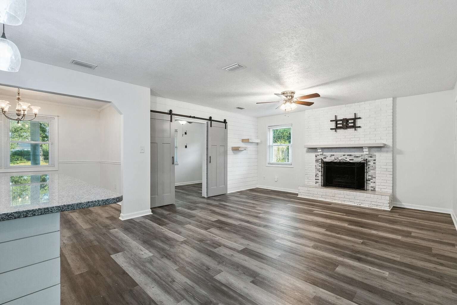 3961 Painter Branch Road Crestview, FL 32539 - Photo 4 of 49 a view of an empty room with a fireplace and a window