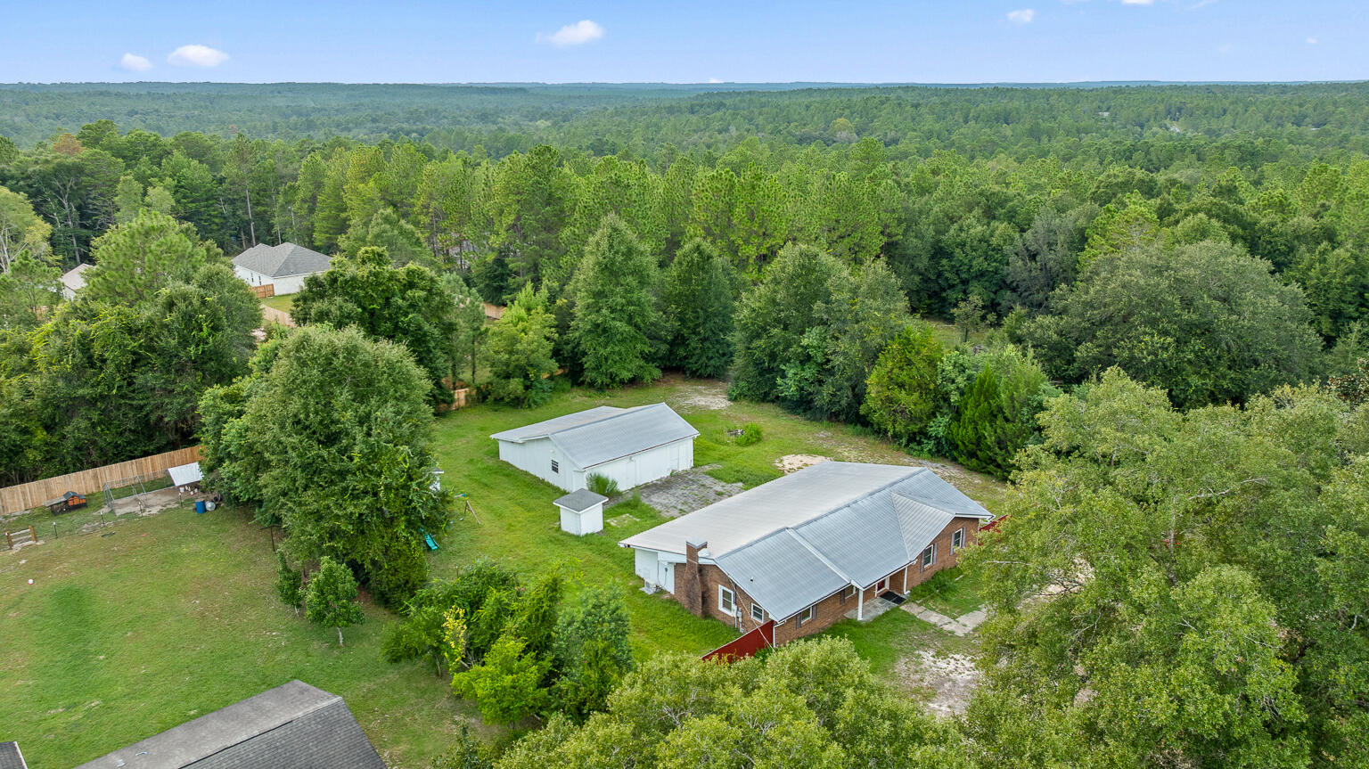 3961 Painter Branch Road Crestview, FL 32539 - Photo 47 of 49 a view of a backyard with plants and a garden