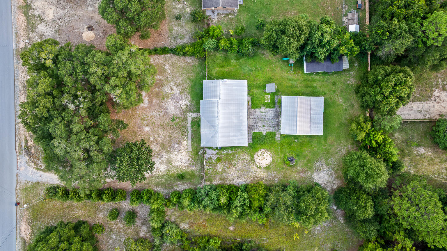 3961 Painter Branch Road Crestview, FL 32539 - Photo 48 of 49 an aerial view of a house with swimming pool and garden