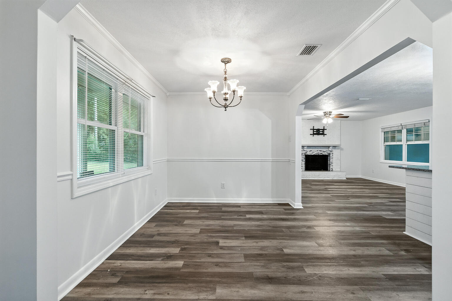 3961 Painter Branch Road Crestview, FL 32539 - Photo 6 of 49 a view of empty room with wooden floor and fan