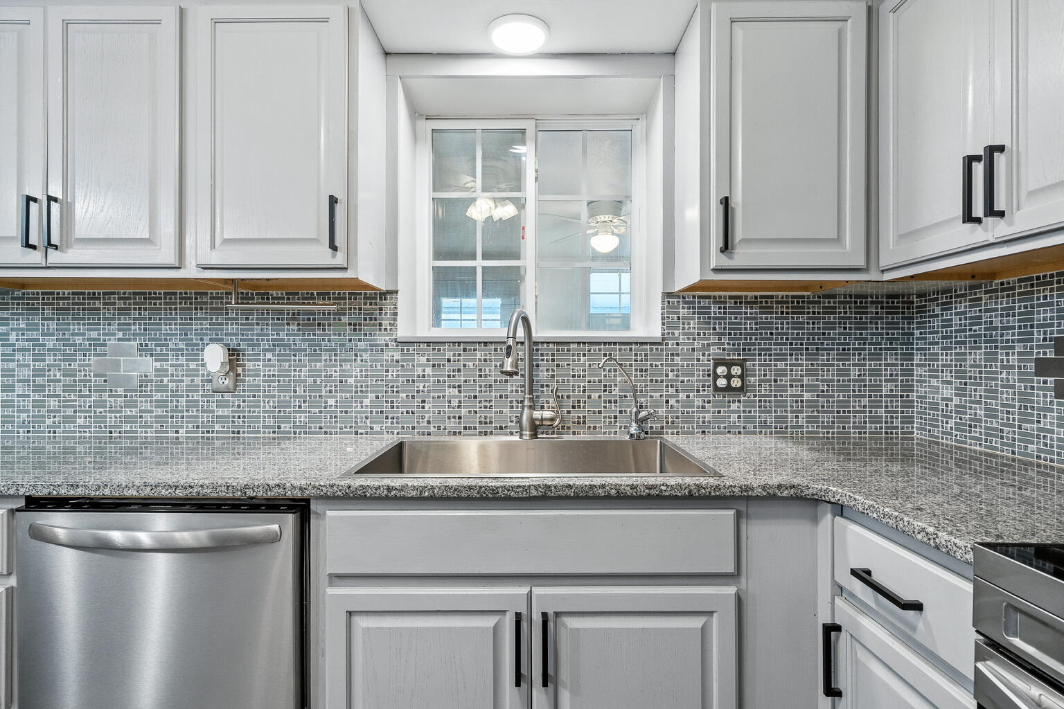 3961 Painter Branch Road Crestview, FL 32539 - Photo 9 of 49 a kitchen with granite countertop a sink and cabinets