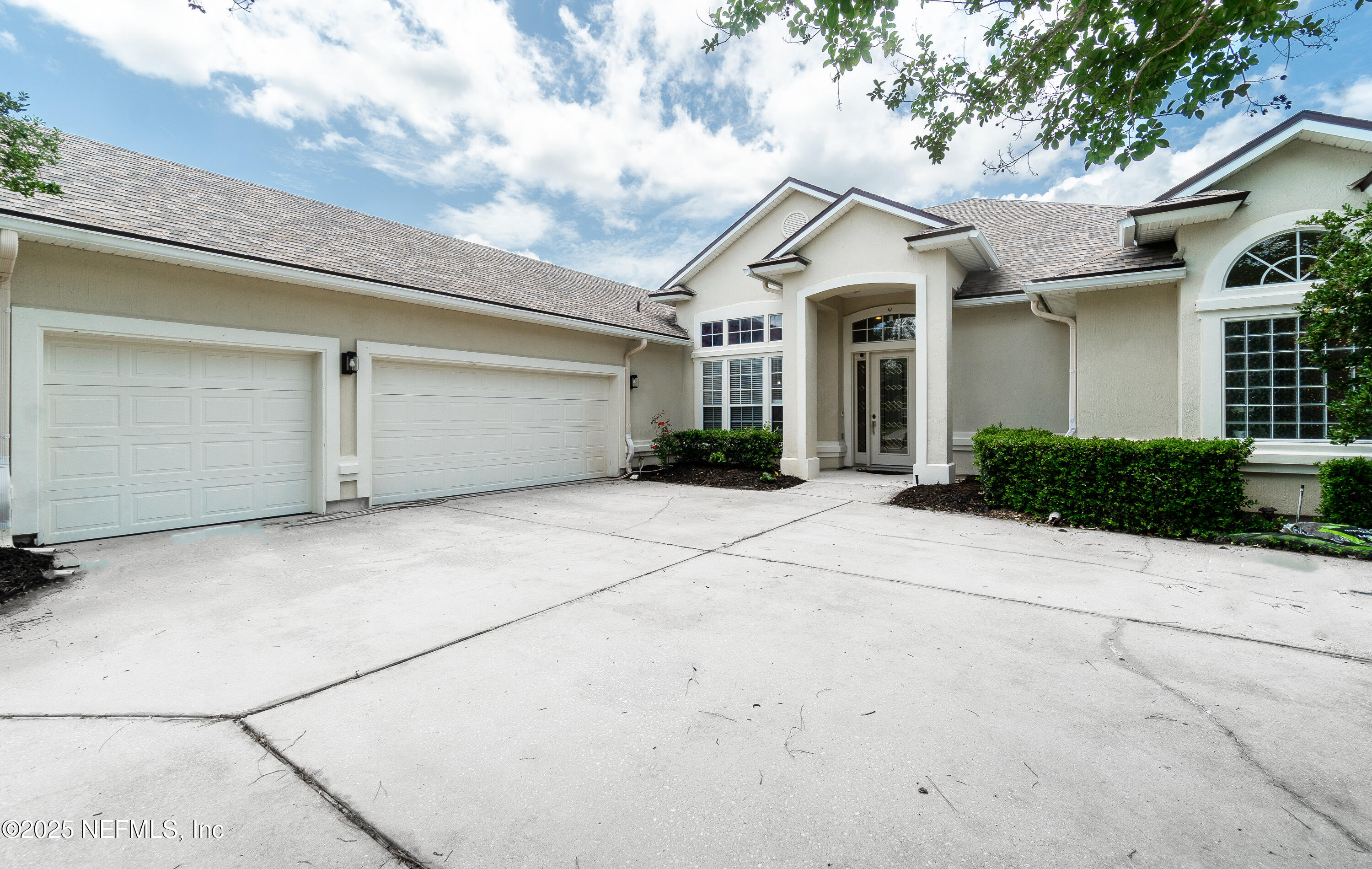 a view of a white house with a outdoor space