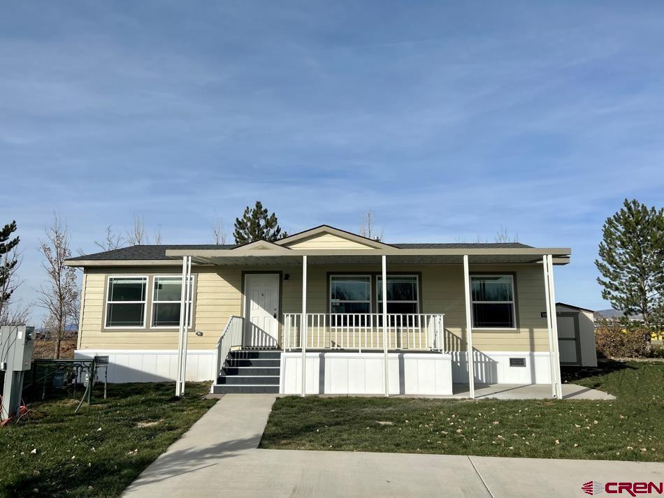 901 6530 Road, Unit 1414 Montrose, CO 81401 - Photo 1 of 16 a front view of a house with a yard