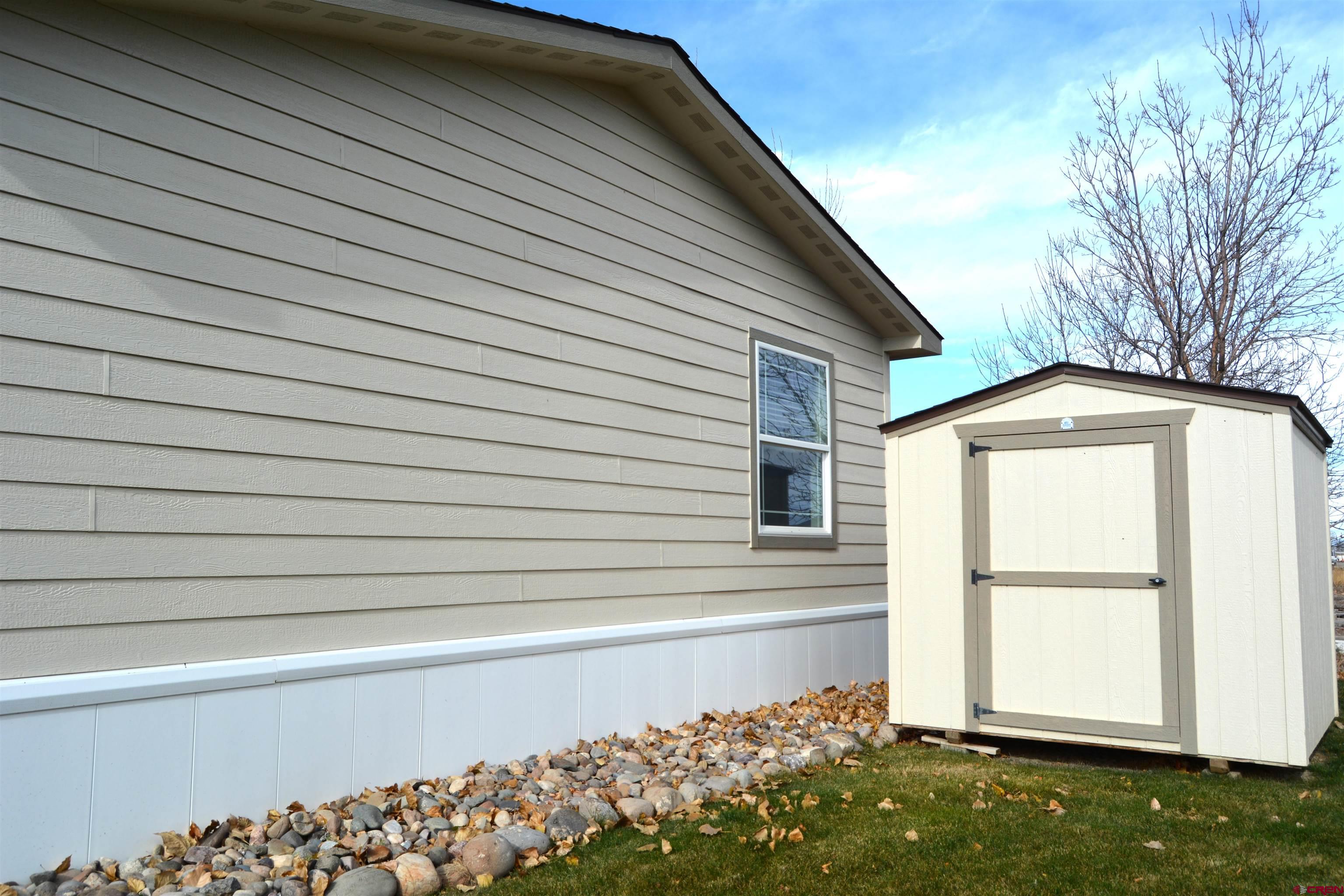 901 6530 Road, Unit 1414 Montrose, CO 81401 - Photo 12 of 16 a front view of a house with a yard