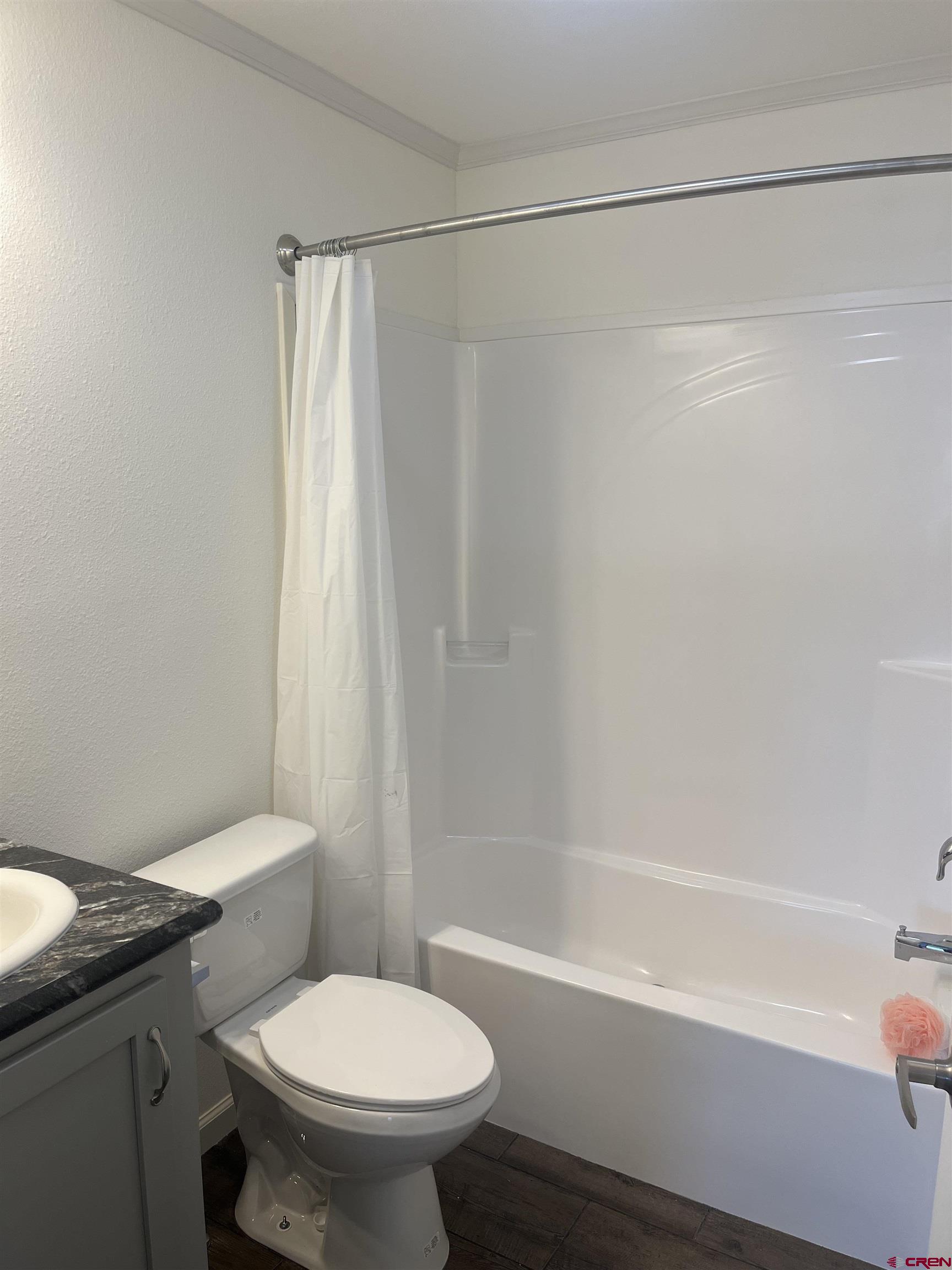 901 6530 Road, Unit 1414 Montrose, CO 81401 - Photo 7 of 16 a white toilet sitting next to a bath tub