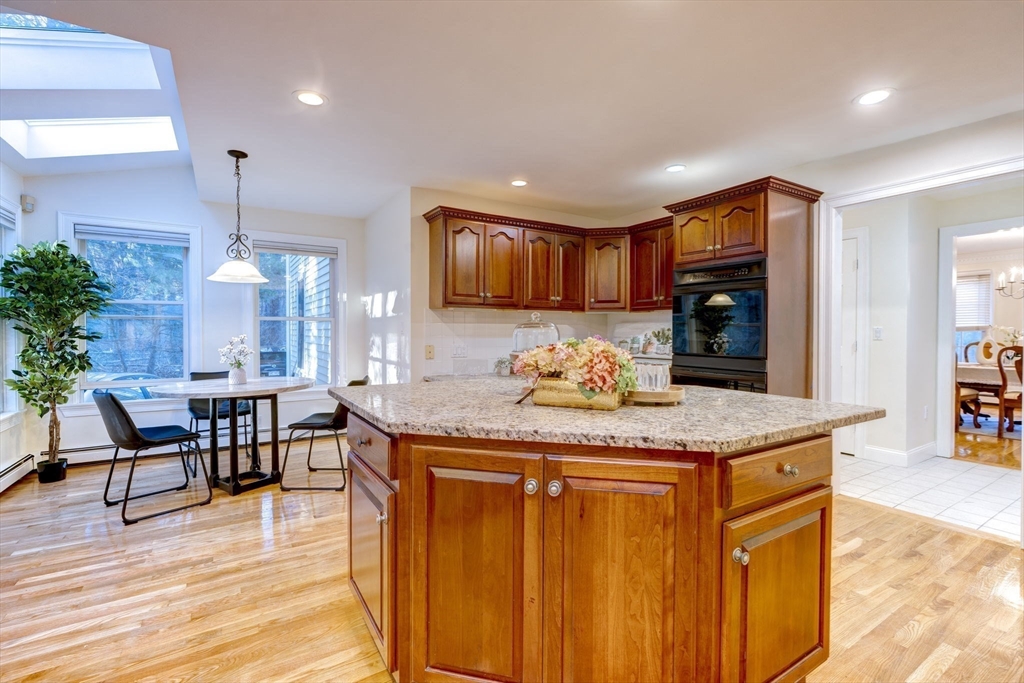 17 Bridle Path Walpole, MA 02081 - Photo 15 of 38 a kitchen with kitchen island granite countertop wooden cabinets and a counter top space