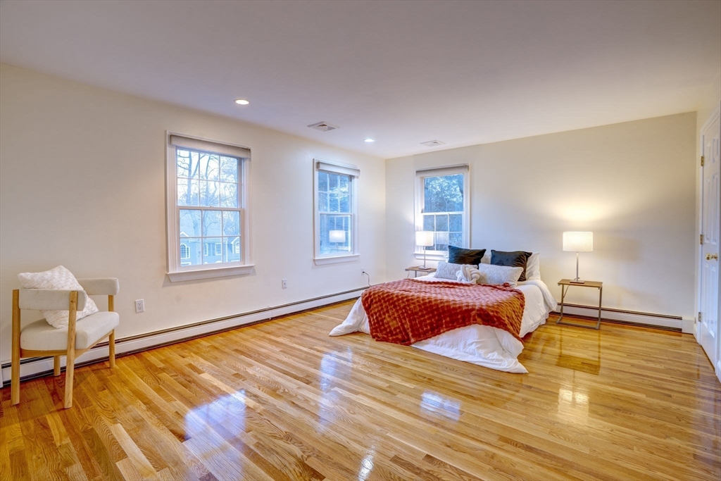 17 Bridle Path Walpole, MA 02081 - Photo 18 of 38 a bedroom with a bed and wooden floor