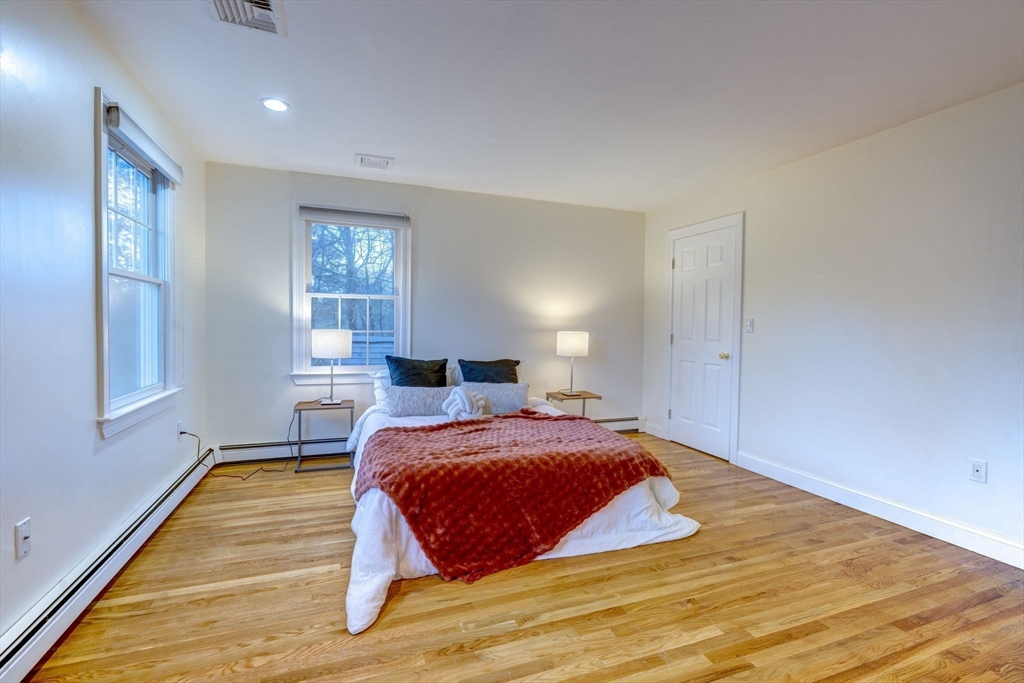 17 Bridle Path Walpole, MA 02081 - Photo 19 of 38 a bedroom with a bed and wooden floor
