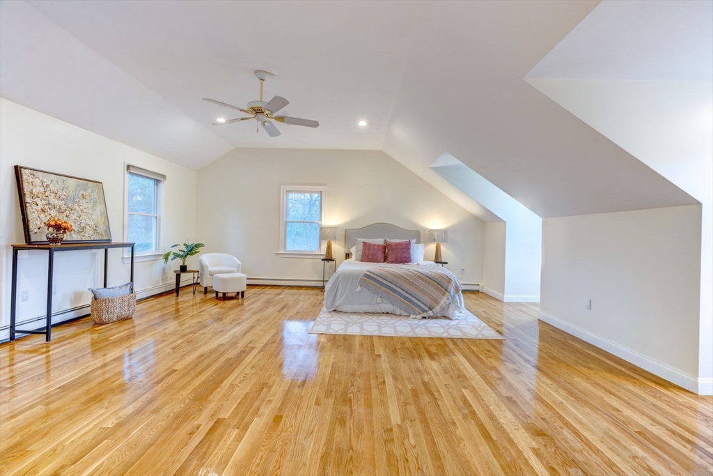 17 Bridle Path Walpole, MA 02081 - Photo 23 of 38 a spacious bedroom with a bed and wooden floor