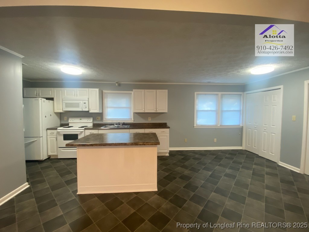 6527 Tareyton Road Fayetteville, NC 28314 - Photo 4 of 11 a kitchen with stainless steel appliances granite countertop a stove a sink and a refrigerator