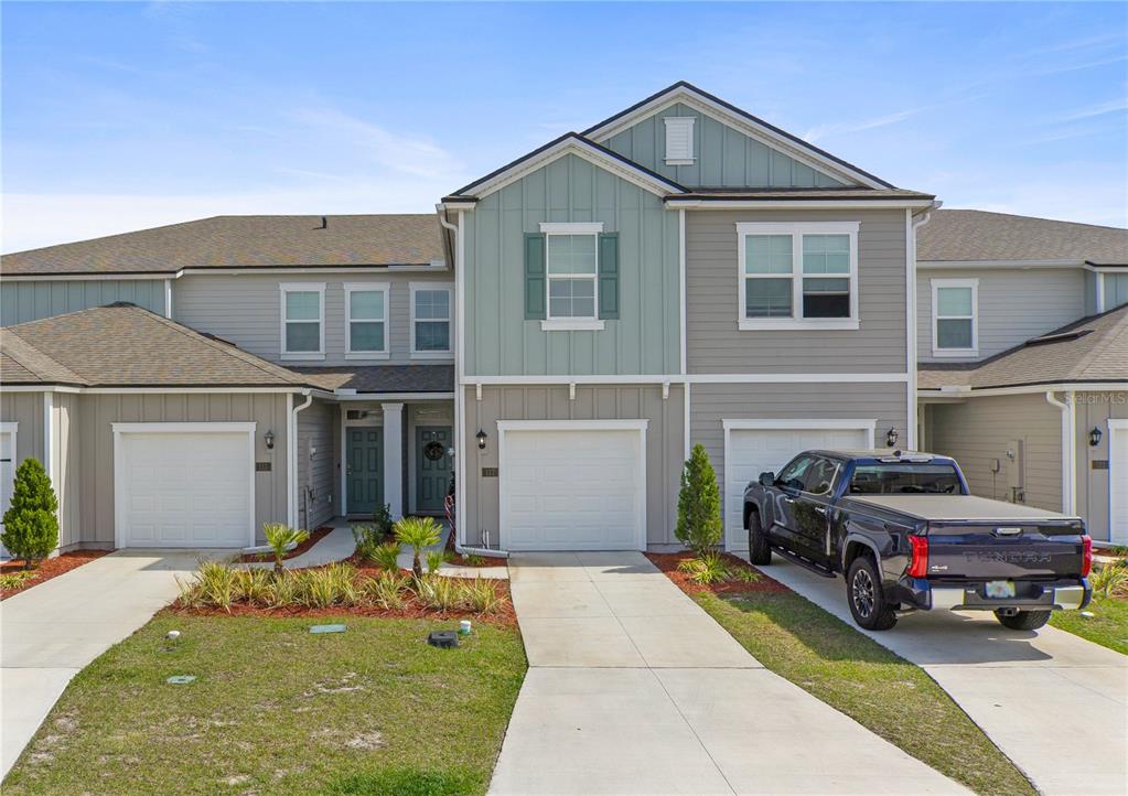 a front view of a house with a yard and garage